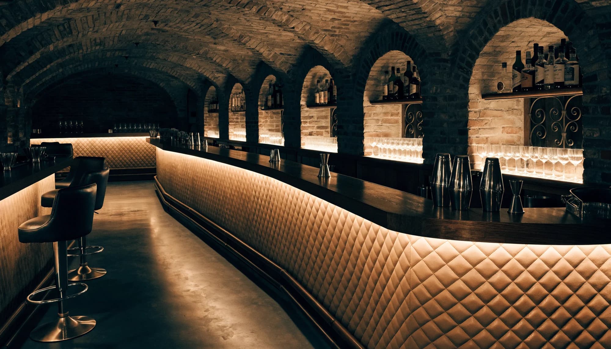 Zvlněný bar Secret Door s prošívaným koženým pultem nasvíceným zespodu